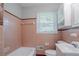 Bathroom features a tub, sink, and a window at 573 Allgood Rd, Stone Mountain, GA 30083