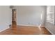 Bright bedroom features beautiful hardwood floors and neutral paint at 573 Allgood Rd, Stone Mountain, GA 30083