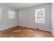 This bedroom has lovely hardwood floors and two windows at 573 Allgood Rd, Stone Mountain, GA 30083