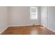 This bedroom has lovely hardwood floors, a window, and a closet space at 573 Allgood Rd, Stone Mountain, GA 30083
