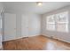 Cozy bedroom with hardwood floors, natural light, and closet space at 573 Allgood Rd, Stone Mountain, GA 30083