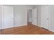 Spacious bedroom features hardwood floors, closet, and neutral paint at 573 Allgood Rd, Stone Mountain, GA 30083