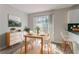 Dining area with a light wood table, white chairs, and sliding glass door at 573 Allgood Rd, Stone Mountain, GA 30083