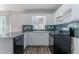 Traditional-style kitchen features white cabinetry and appliances with a black gas range at 573 Allgood Rd, Stone Mountain, GA 30083