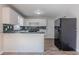 Functional kitchen featuring white cabinets, a breakfast bar, and new appliances at 573 Allgood Rd, Stone Mountain, GA 30083