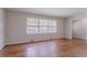 Sunny living room showcases hardwood floors and a large window with views of the street at 573 Allgood Rd, Stone Mountain, GA 30083