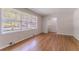 Bright living room boasts hardwood floors and large windows with scenic neighborhood views at 573 Allgood Rd, Stone Mountain, GA 30083
