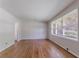 Sun-filled living room with hardwood floors and large windows offering neighborhood views at 573 Allgood Rd, Stone Mountain, GA 30083