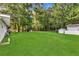 Large, grassy backyard with mature trees and a shed offers plenty of space for outdoor activities at 288 Valerie Cir, Hiram, GA 30141