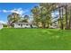 Expansive backyard featuring a large green lawn and mature trees provides ample space for outdoor activities at 288 Valerie Cir, Hiram, GA 30141