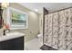 Updated bathroom featuring a stylish vanity, marbled tile flooring, and a shower with a marble curtain at 288 Valerie Cir, Hiram, GA 30141
