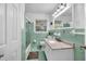 Freshly updated bathroom with retro green tiling, a new vanity, and a bathtub with shower at 288 Valerie Cir, Hiram, GA 30141