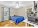 Bright bedroom featuring hardwood floors, two windows, and blue curtains at 288 Valerie Cir, Hiram, GA 30141