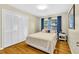 Cozy bedroom with hardwood floors, a comfortable bed, and ample closet space for storage at 288 Valerie Cir, Hiram, GA 30141