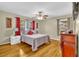 Warm bedroom featuring hardwood floors, a comfortable bed, and natural light from the windows at 288 Valerie Cir, Hiram, GA 30141