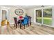 Dining room with stylish chairs, wood-look vinyl flooring, and a sliding glass door to the backyard at 288 Valerie Cir, Hiram, GA 30141