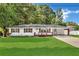 Charming single-story home featuring a well-manicured lawn, a covered porch, and a long driveway at 288 Valerie Cir, Hiram, GA 30141