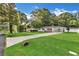 View of the well-maintained home with a spacious front yard and a long driveway on a sunny day at 288 Valerie Cir, Hiram, GA 30141