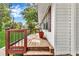View of the wooden front porch with railings and a glimpse of the home's white exterior at 288 Valerie Cir, Hiram, GA 30141