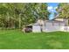 View of the back of the property showing a large garage with multiple bays and storage sheds at 288 Valerie Cir, Hiram, GA 30141