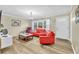 Inviting living room with neutral walls, wood floors, and a bright window creates a warm atmosphere at 288 Valerie Cir, Hiram, GA 30141