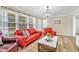 Cozy living room filled with natural light, wood-look vinyl flooring, and comfortable seating at 288 Valerie Cir, Hiram, GA 30141