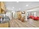 Open-concept living space with a kitchen area and a cozy living room setup with red furniture and a view at 288 Valerie Cir, Hiram, GA 30141