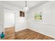 A bright dining room with white walls, wood floors, and a window for natural light at 4103 Laynewood Cir, Tucker, GA 30084