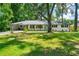 Charming single-story home with a lush green lawn and mature trees surrounding the property at 4103 Laynewood Cir, Tucker, GA 30084