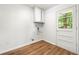 An efficient laundry area with storage cabinet and a door to the outside at 4103 Laynewood Cir, Tucker, GA 30084