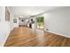 Spacious living room with wood floors, leading to a modern kitchen and an outdoor deck at 4103 Laynewood Cir, Tucker, GA 30084