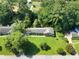 Aerial view of home with large front lawn and surrounding mature trees in neighborhood at 4581 Newcastle Cir, Lithonia, GA 30038