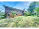 Back exterior showcasing a spacious yard and brick facade of the home at 4581 Newcastle Cir, Lithonia, GA 30038