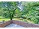 Brick patio area with a view of the beautifully landscaped backyard at 4581 Newcastle Cir, Lithonia, GA 30038
