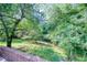 Brick patio area with a view of the beautifully landscaped backyard at 4581 Newcastle Cir, Lithonia, GA 30038