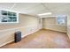 Unfinished basement space featuring light wood flooring, neutral walls and two windows for natural light at 4581 Newcastle Cir, Lithonia, GA 30038