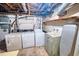 Basement laundry area with washer, dryer, utility sink, and exposed pipes at 4581 Newcastle Cir, Lithonia, GA 30038