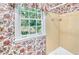 Vintage bathroom with floral wallpaper and a tiled shower/tub combination at 4581 Newcastle Cir, Lithonia, GA 30038