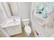 A well-lit bathroom featuring a vanity, toilet, and classic tile flooring at 4581 Newcastle Cir, Lithonia, GA 30038