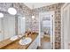 A retro-style bathroom featuring double sinks, vintage wallpaper, and pendant lighting at 4581 Newcastle Cir, Lithonia, GA 30038