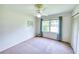 Bright bedroom with a ceiling fan, large window, and a neutral carpet at 4581 Newcastle Cir, Lithonia, GA 30038