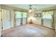 A bright bedroom with natural lighting, neutral paint, two windows and a ceiling fan at 4581 Newcastle Cir, Lithonia, GA 30038