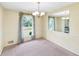 Cozy dining room with a chandelier, large window, and decorative mirror at 4581 Newcastle Cir, Lithonia, GA 30038