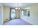 Inviting dining room with chandelier, soft carpet, and natural light, perfect for Gathering gatherings at 4581 Newcastle Cir, Lithonia, GA 30038