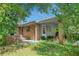 Charming brick home exterior featuring a covered porch and mature landscaping at 4581 Newcastle Cir, Lithonia, GA 30038