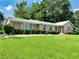 Brick home with meticulously maintained front lawn and manicured hedges at 4581 Newcastle Cir, Lithonia, GA 30038