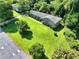 Aerial view of a well-maintained brick home with a lush green lawn and mature trees at 4581 Newcastle Cir, Lithonia, GA 30038