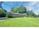 Charming single story brick home featuring shutters, mature trees and beautiful lawn at 4581 Newcastle Cir, Lithonia, GA 30038