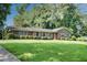 Charming brick home with a well-manicured lawn, lush greenery, and inviting curb appeal at 4581 Newcastle Cir, Lithonia, GA 30038