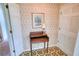 Welcoming hallway featuring a classic writing desk, complemented by patterned wallpaper and flooring at 4581 Newcastle Cir, Lithonia, GA 30038